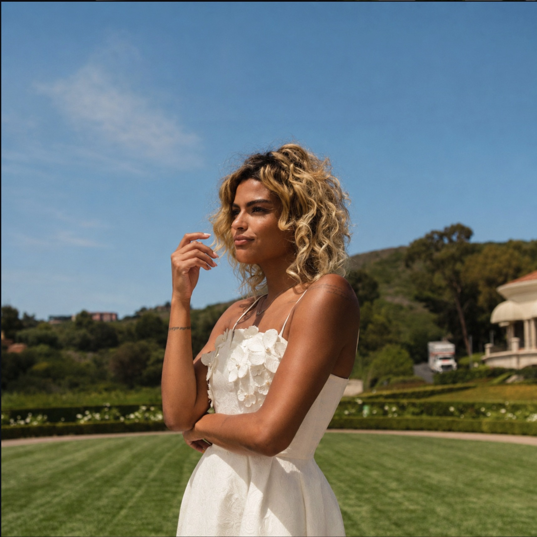 Fashion portrait in a white dress on an estate lawn